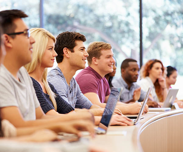 students in a lecture with computers